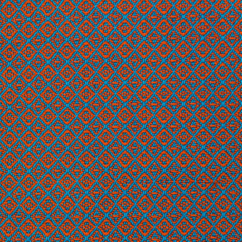 swatch woven with orange and blue yarns. The pattern looks blurry and indistinct.