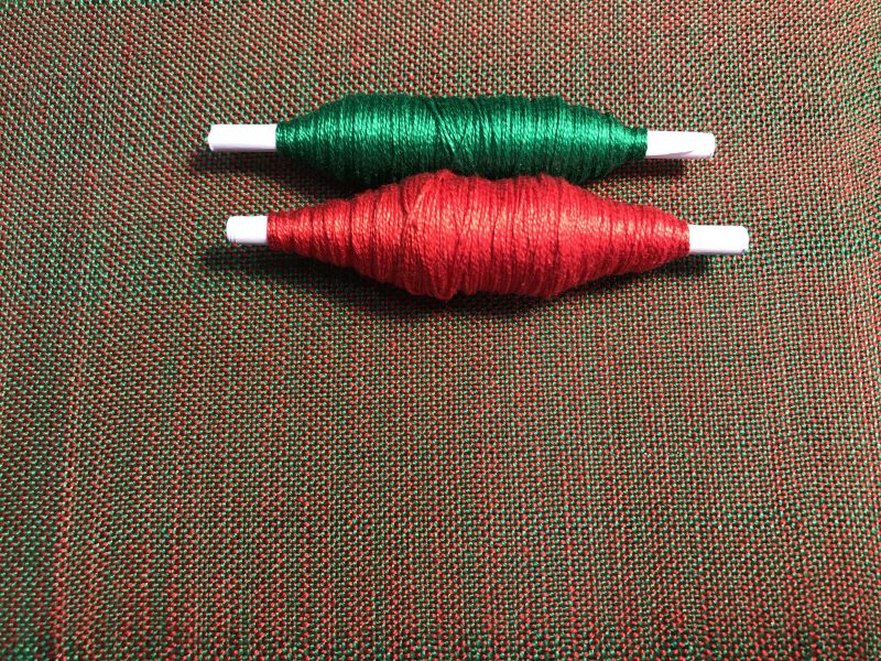 Red and green plain weave swatch - a dull brown color.